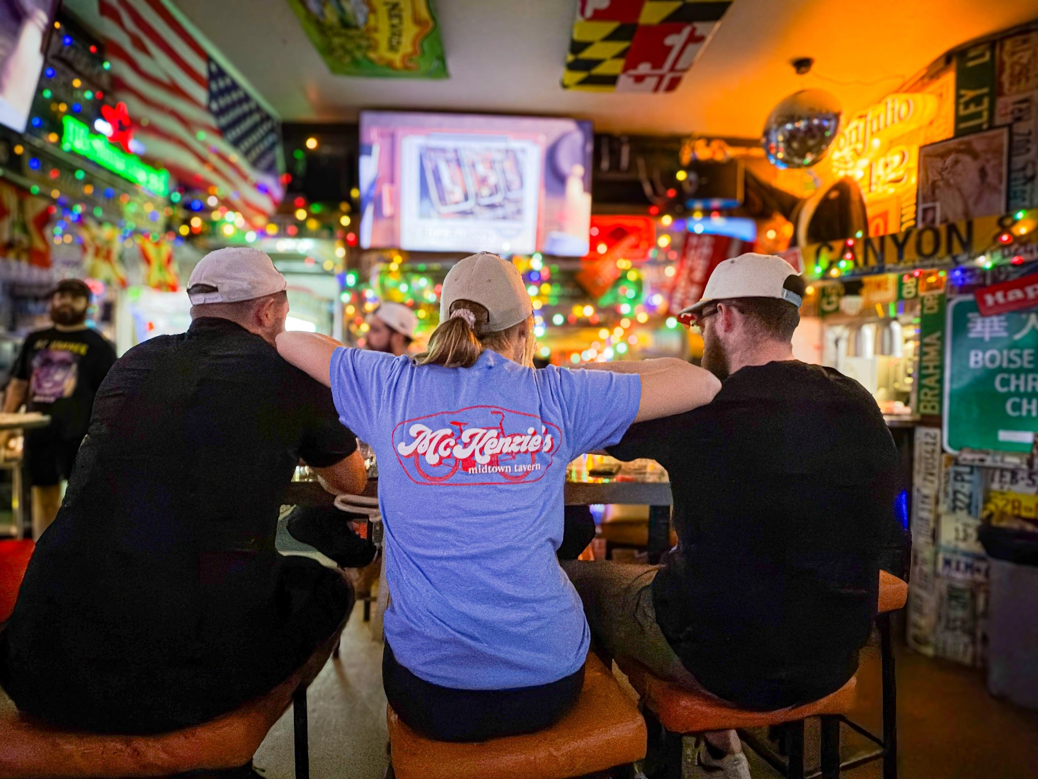 Three people sitting at McKenzie's bar